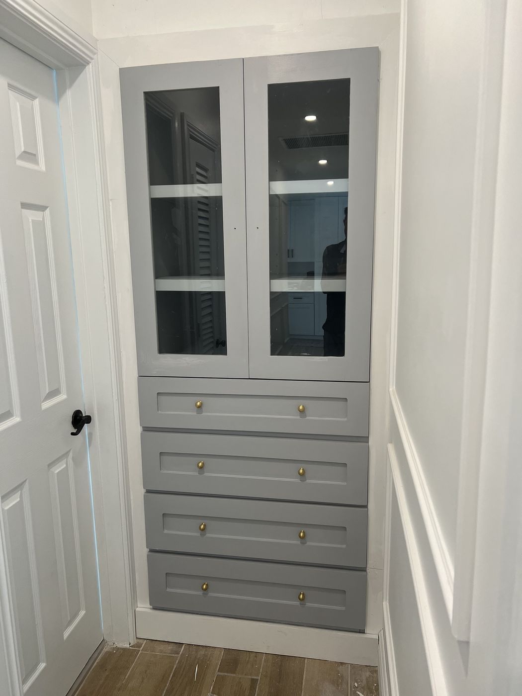 Grey hallway built-in with glass doors over four drawers